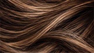 Close-up of brunette hair with soft golden highlights